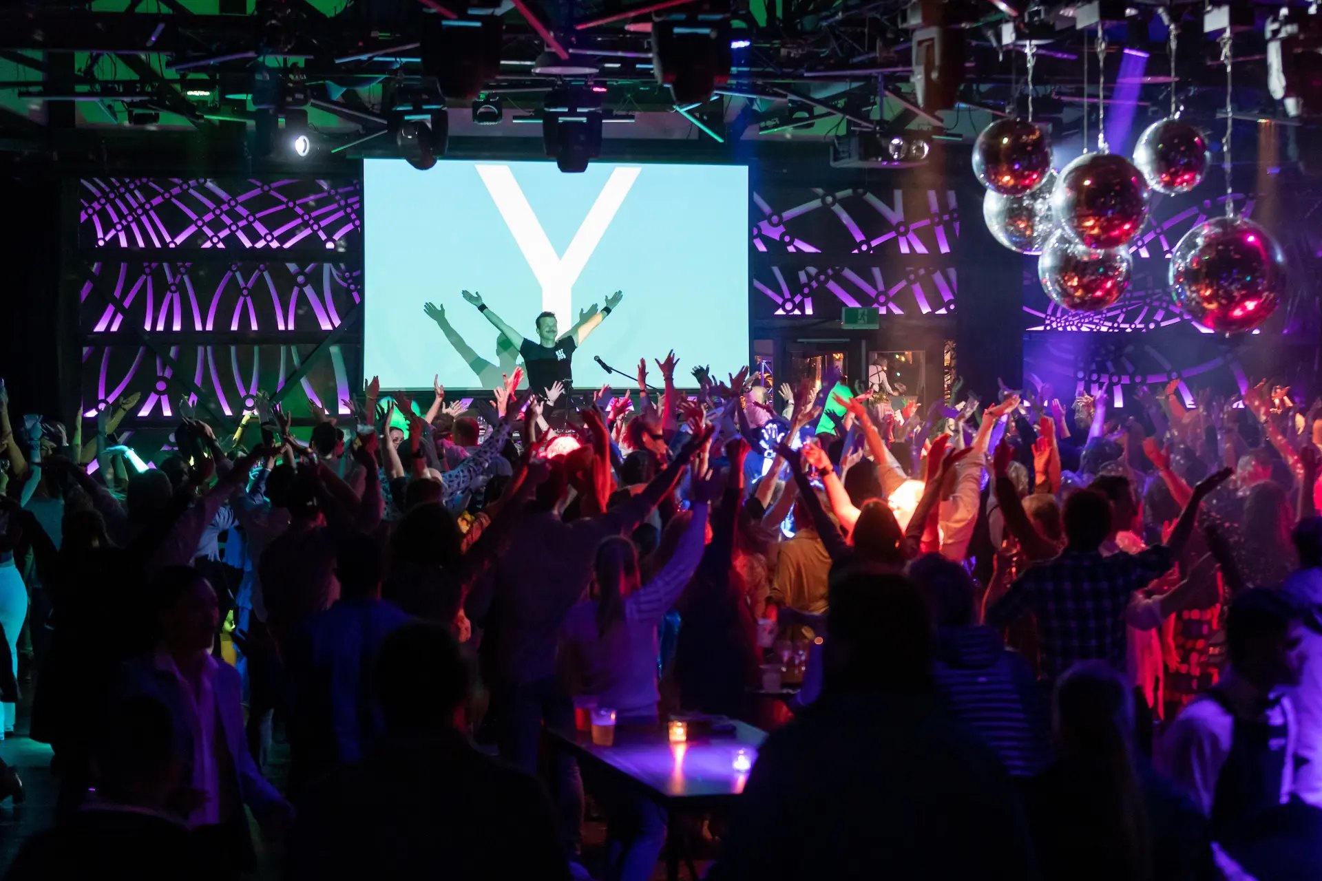Delegates celebrating on the dance floor at a conference after party