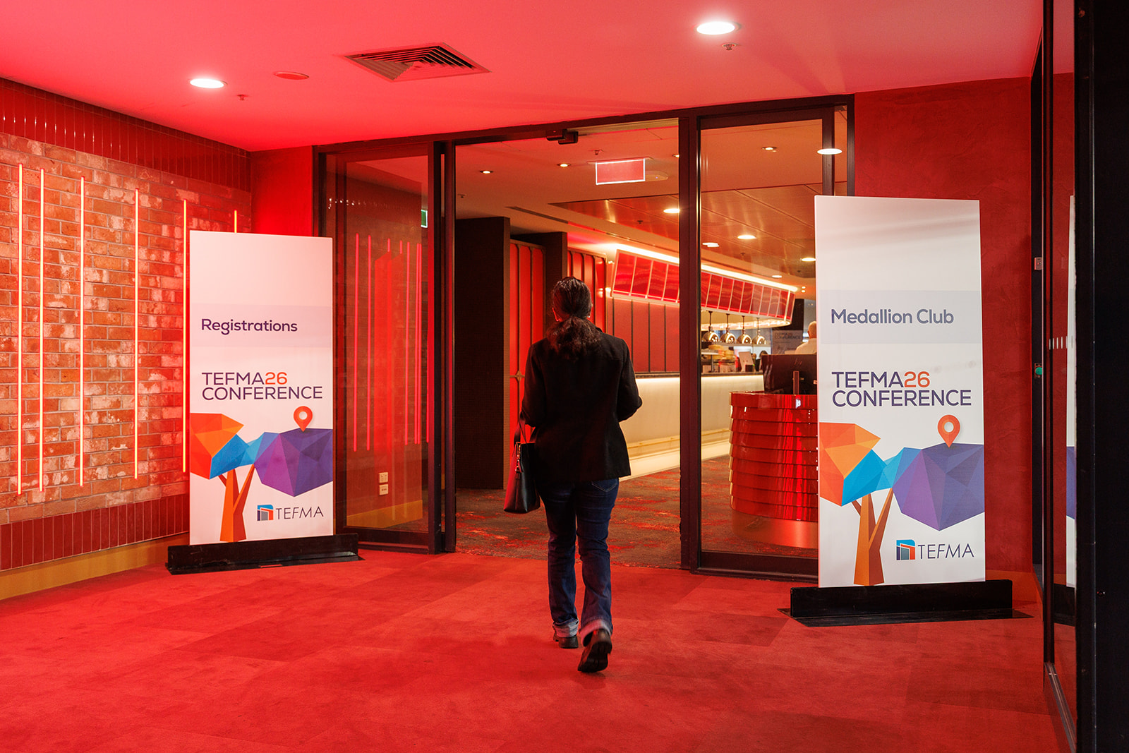 A delegate arriving at TEFMA26 registration at the Medallion Club entrance