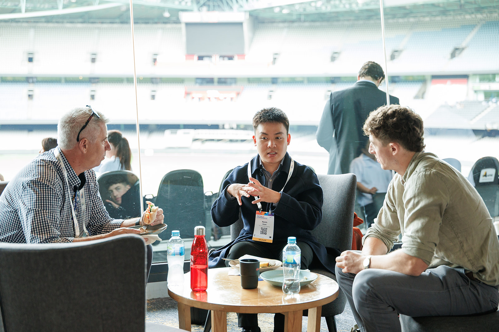Three association professionals talking together over coffee at a conference