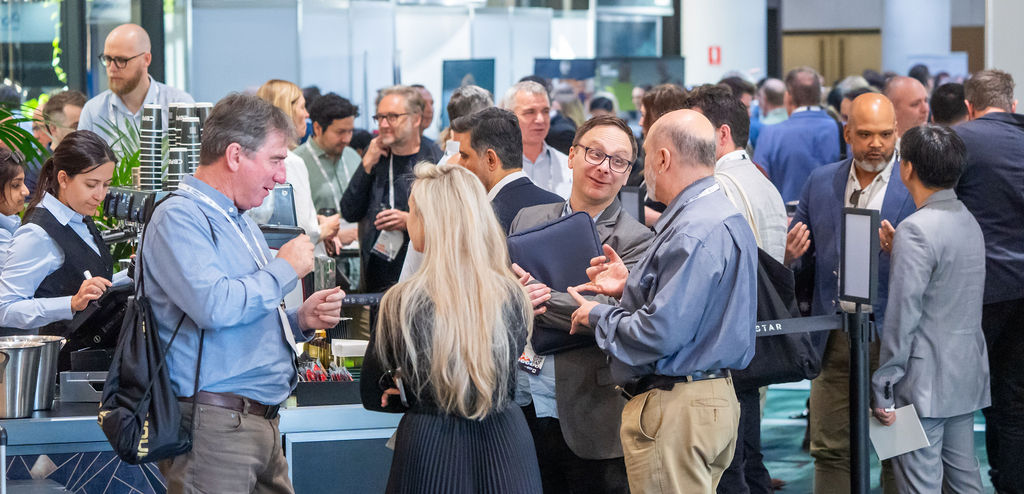 Association professionals in conversation around a coffee cart at a conference